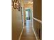 Bright hallway showcasing modern laminate floors and access to various rooms in the home at 3615 Pine Knot Dr, Valrico, FL 33596