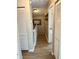 Bright upstairs hallway with fresh paint, wood floors, and convenient access to linen closet at 3615 Pine Knot Dr, Valrico, FL 33596