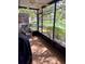 Screened patio with seating offers a relaxing view of the pond and landscaping at 3615 Pine Knot Dr, Valrico, FL 33596