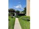 Landscaped walkway leading to a community entrance at 3615 Pine Knot Dr, Valrico, FL 33596