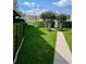 Landscaped walkway leading to a community pool, surrounded by lush greenery and manicured hedges at 3615 Pine Knot Dr, Valrico, FL 33596