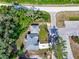 Aerial view showcasing the home's layout, surrounded by lush greenery and highlighting property boundaries at 37230 Poinsettia Ave, Dade City, FL 33525