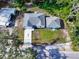 Aerial view of the property showcasing its layout with a well-manicured lawn and surrounding trees at 37230 Poinsettia Ave, Dade City, FL 33525