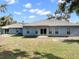 Spacious backyard featuring a well-maintained lawn, perfect for outdoor activities and relaxation at 37230 Poinsettia Ave, Dade City, FL 33525