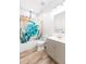 Bathroom featuring a vanity sink, toilet, and shower with a decorative curtain at 37230 Poinsettia Ave, Dade City, FL 33525