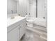 Updated bathroom featuring stylish vanity, toilet, and tiled shower/tub with modern fixtures and lighting at 37230 Poinsettia Ave, Dade City, FL 33525