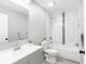 Modern bathroom featuring a vanity, toilet, and tub with decorative tile, offering a stylish design at 37230 Poinsettia Ave, Dade City, FL 33525