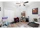 Bedroom featuring a ceiling fan, double door closet, and a window with blinds at 37230 Poinsettia Ave, Dade City, FL 33525