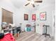 Bedroom featuring a ceiling fan, window with blinds, and sports memorabilia at 37230 Poinsettia Ave, Dade City, FL 33525