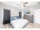Bedroom features light gray walls, light vinyl floors, and neutral-colored furnishings at 37230 Poinsettia Ave, Dade City, FL 33525