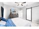 Bedroom with gray walls, light wood floors, and barn door to bathroom at 37230 Poinsettia Ave, Dade City, FL 33525
