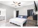 Bedroom featuring hardwood floors, ceiling fan, ensuite bathroom, and large dresser at 37230 Poinsettia Ave, Dade City, FL 33525