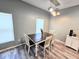Well-lit dining room with modern lighting and a view out the window at 37230 Poinsettia Ave, Dade City, FL 33525