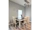 Dining room featuring a rustic wood table, four chairs, and a modern chandelier at 37230 Poinsettia Ave, Dade City, FL 33525