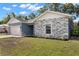 Attractive one-story home with stone veneer, a two-car garage, and landscaped front yard at 37230 Poinsettia Ave, Dade City, FL 33525