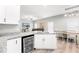 Open kitchen with island, white cabinets, wine cooler, and adjacent dining area at 37230 Poinsettia Ave, Dade City, FL 33525