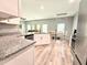 Bright kitchen with granite countertops, stainless appliances, and an open layout at 37230 Poinsettia Ave, Dade City, FL 33525