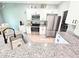 Bright kitchen with stainless steel appliances, granite countertops, and stylish white cabinetry at 37230 Poinsettia Ave, Dade City, FL 33525