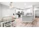 Spacious kitchen features stainless steel appliances, white cabinets, and an island with granite countertops at 37230 Poinsettia Ave, Dade City, FL 33525