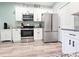 Well-lit kitchen boasts stainless steel appliances, ample counter space, and bright white cabinetry at 37230 Poinsettia Ave, Dade City, FL 33525