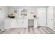 Kitchenette with white cabinets and vinyl floors at 37230 Poinsettia Ave, Dade City, FL 33525