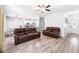 Open-concept living room with wood floors that flows into kitchen and dining area at 37230 Poinsettia Ave, Dade City, FL 33525