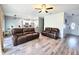 Open living space with a view into the kitchen and dining area featuring wood floors at 37230 Poinsettia Ave, Dade City, FL 33525