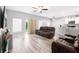 Spacious living room with wood floors and an open layout to the kitchen and dining area at 37230 Poinsettia Ave, Dade City, FL 33525
