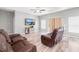 Cozy living room with wood floors, ceiling fan, and plenty of natural light at 37230 Poinsettia Ave, Dade City, FL 33525
