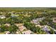 Aerial view showcases the neighborhood's layout with trees, a lake, and the subject property at 3922 Cedar Cay Circle, Valrico, FL 33596