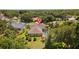 Aerial view showcasing the house and neighborhood with mature landscaping and lush, green trees at 3922 Cedar Cay Circle, Valrico, FL 33596