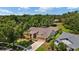 Wide aerial view of a beautiful house surrounded by mature landscaping and trees at 3922 Cedar Cay Circle, Valrico, FL 33596