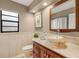 Charming bathroom with vessel sink, marble countertop, decorative mirror, and natural light from a window at 3922 Cedar Cay Circle, Valrico, FL 33596