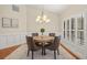 Dining area featuring neutral walls, modern chandelier, and window shutters for a sleek look at 3922 Cedar Cay Circle, Valrico, FL 33596