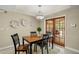 Formal dining room features neutral paint, modern chandelier, and glass doors to the patio at 3922 Cedar Cay Circle, Valrico, FL 33596