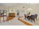 Open dining room with views to living area, stylish furniture, and French doors at 3922 Cedar Cay Circle, Valrico, FL 33596