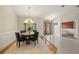 Bright dining area with modern chandelier, decorative wainscoting, and view of the home's entry at 3922 Cedar Cay Circle, Valrico, FL 33596