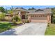Well-maintained single-story home featuring brick accents, neutral stucco and a two-car garage in a landscaped yard at 3922 Cedar Cay Circle, Valrico, FL 33596