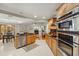 Kitchen showcases a stainless steel appliance suite, granite countertops, and open layout to living areas at 3922 Cedar Cay Circle, Valrico, FL 33596