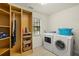Bright laundry room with built-in shelves, and a modern washer and dryer at 3922 Cedar Cay Circle, Valrico, FL 33596