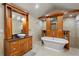 Stylish main bathroom features a soaking tub, granite counters, double vanity, and tiled shower at 3922 Cedar Cay Circle, Valrico, FL 33596