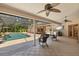 Outdoor patio with ceiling fans, outdoor kitchen, seating, and a view of the screened-in pool at 3922 Cedar Cay Circle, Valrico, FL 33596