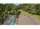 Aerial view of a screened-in pool surrounded by lush greenery, offering a private and serene outdoor space at 3922 Cedar Cay Circle, Valrico, FL 33596
