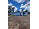 Exterior view of the backyard showing the home's structure with a blue sky at 3950 45Th N Ave, St Petersburg, FL 33714