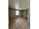 A bedroom featuring neutral walls, tiled floor, and window with blinds providing natural light at 3950 45Th N Ave, St Petersburg, FL 33714