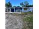 Modest single-story home featuring light blue paint and a dark blue garage door at 3950 45Th N Ave, St Petersburg, FL 33714