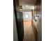 A galley kitchen featuring tile floors, wood cabinets, and modern appliances at 3950 45Th N Ave, St Petersburg, FL 33714