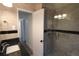 Modern bathroom features a tiled shower with glass door, granite vanity, and updated fixtures at 4105 W Oakellar Ave, Tampa, FL 33611