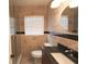 Stylish bathroom featuring tiled walls, granite vanity top, modern fixtures, and window with blinds at 4105 W Oakellar Ave, Tampa, FL 33611