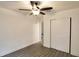 Bright bedroom with wood-look flooring, a ceiling fan, and a closet with sliding doors at 4105 W Oakellar Ave, Tampa, FL 33611